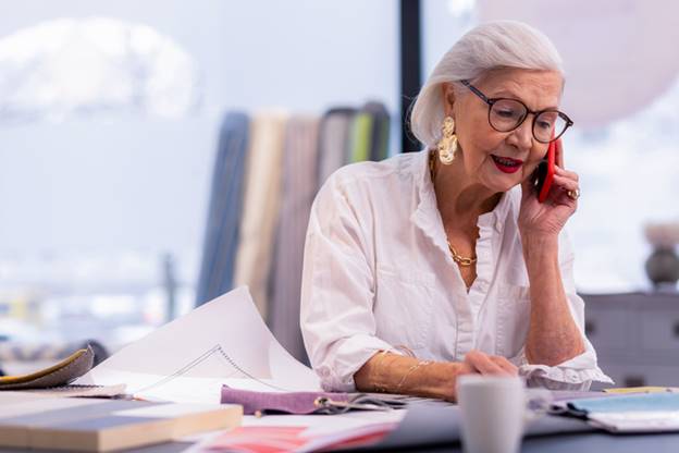 Older woman on the phone at work - Age Discrimination